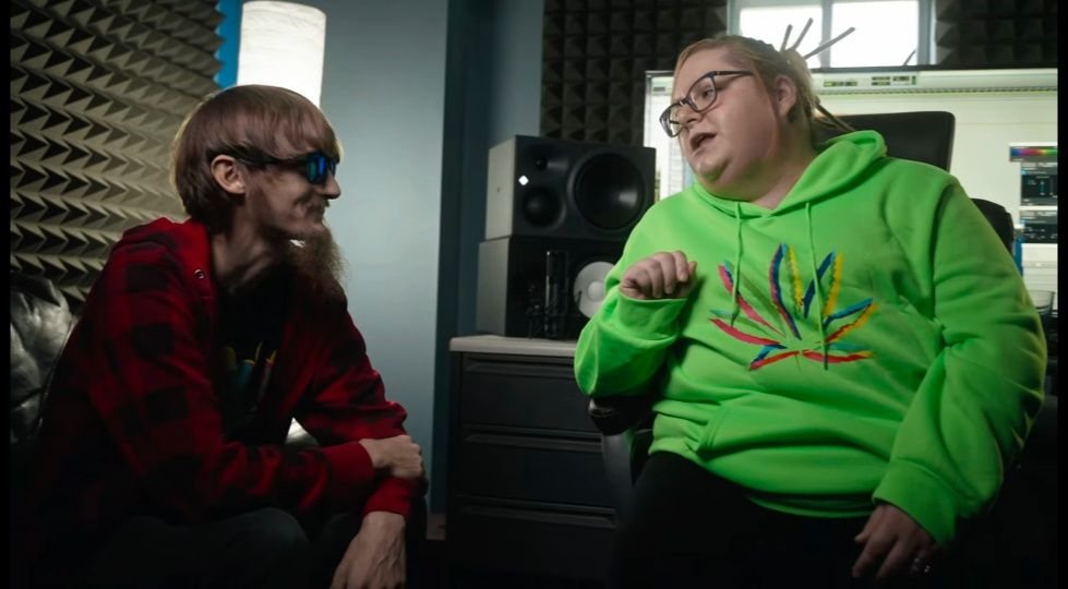 Andrew and his wife Lisa Pompeii talking together in a recording studio